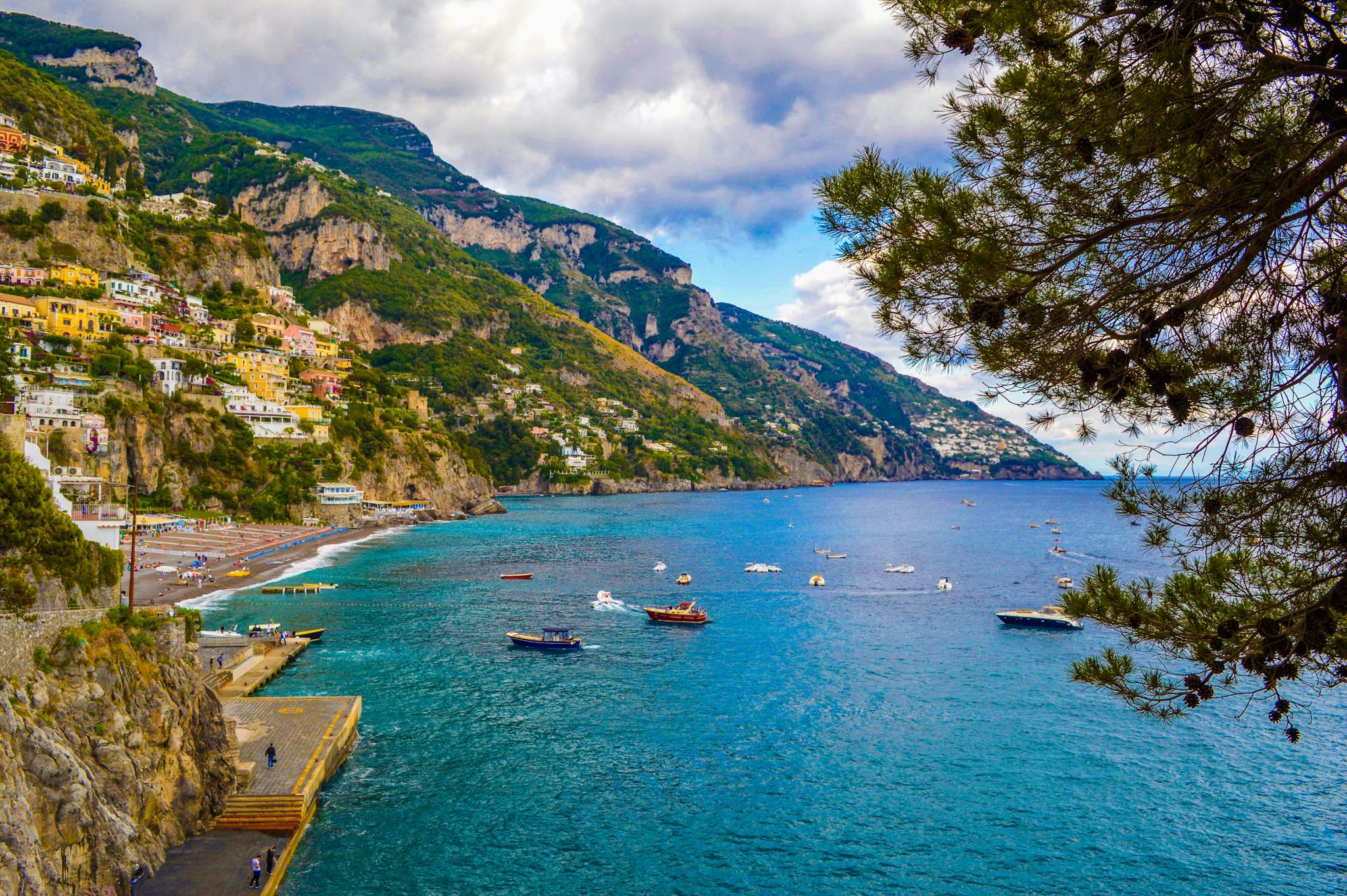 A stunning view of Italy's Amalfi Coast with colorful perched towns and serene blue waters.